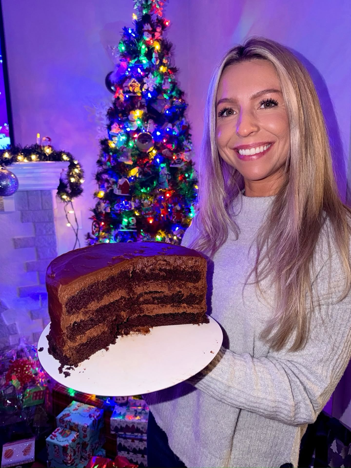 Sugar Mama baker with a three-layer chocolate cake